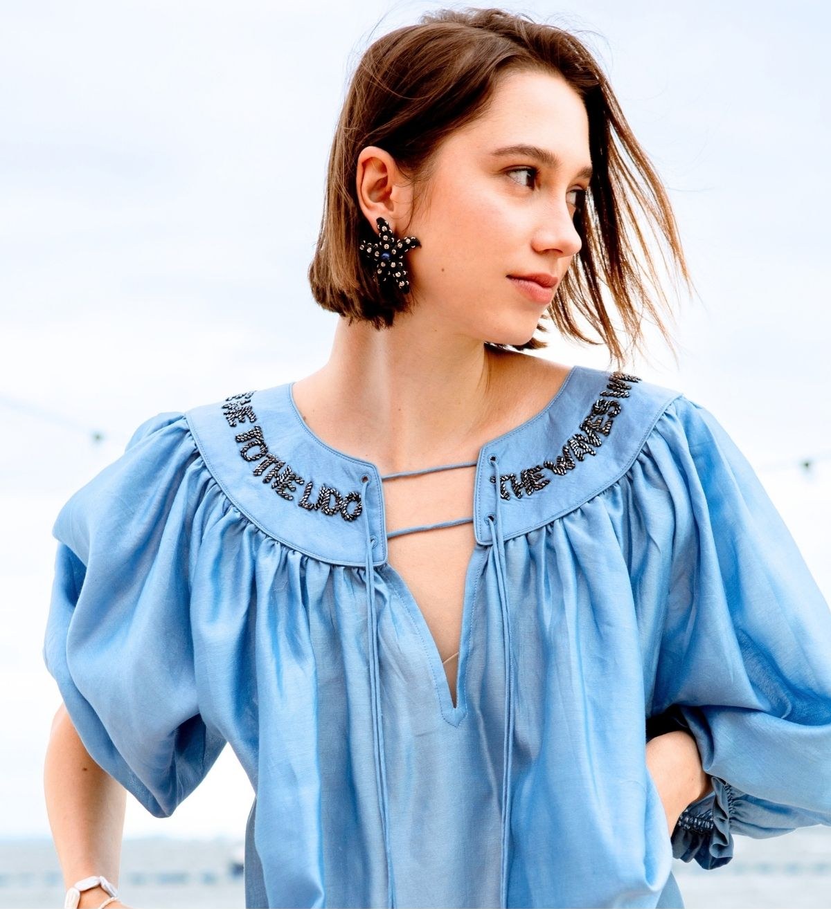A model wearing a Lido Luna blue beaded-collar blouse