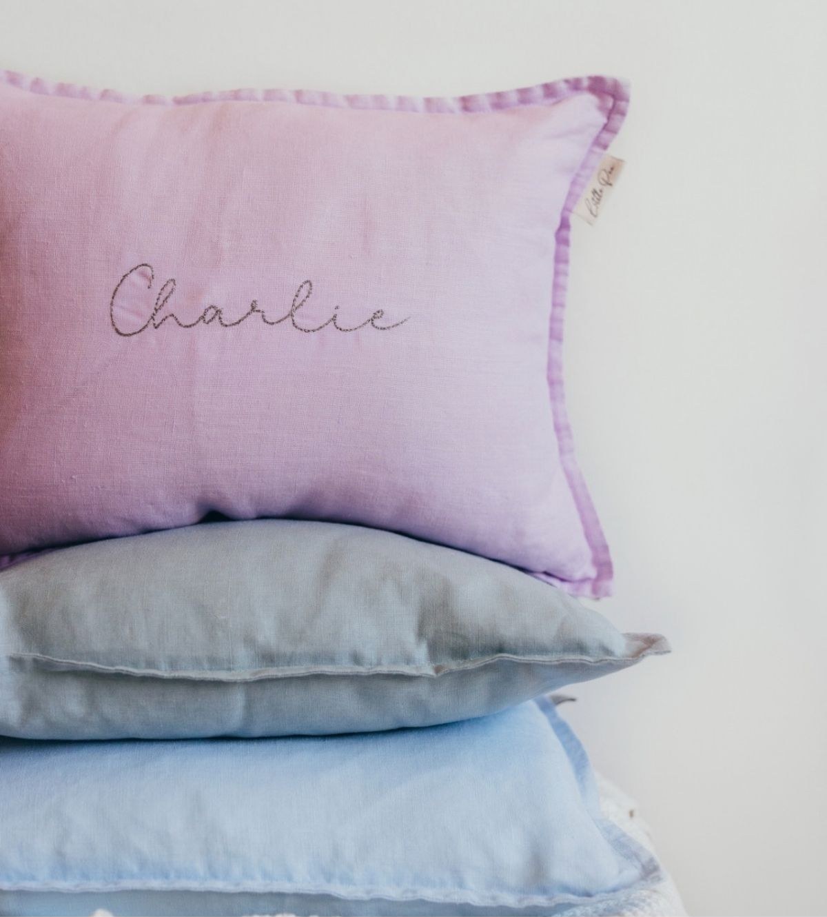 A personalised Little Pea pillow embroidered with the name Charlie