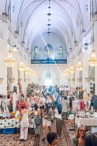 CHIJMES Hall packed with shoppers browsing stalls beneath the vaulted ceiling