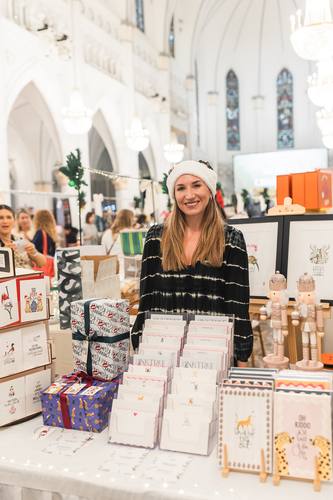 A vendor in a Santa hat at a stationery stall